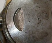 battered piston.jpg battered piston.jpg