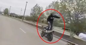 Riding a motorcycle standing up whilst facing backwards.jpg