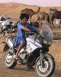 Ibrahim, a particularly cheerful camel herd, tries the Aprilia for size